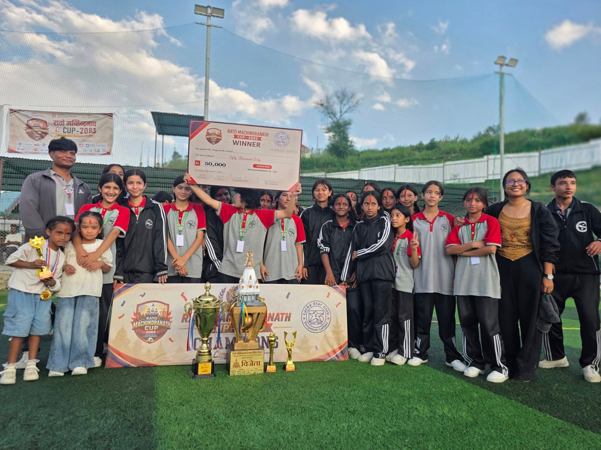 Bloom Nepal School holding the winner’s cheque for the Rato Machhindranath Cup