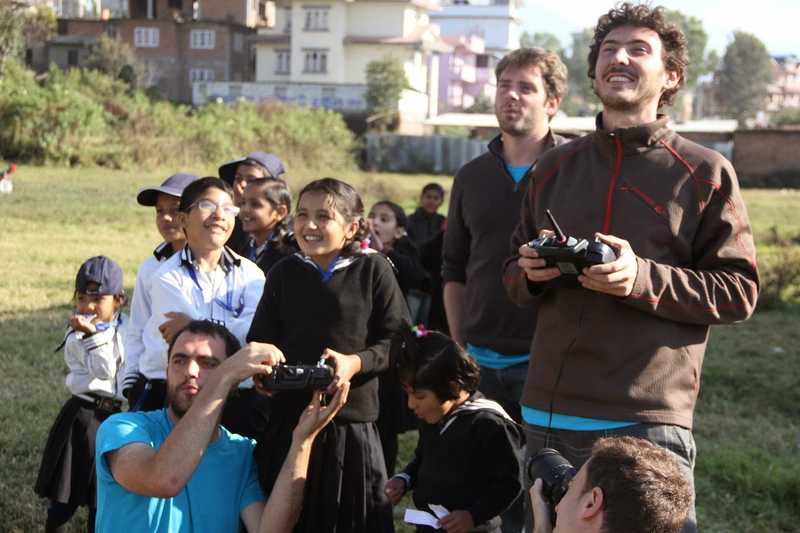 Students flying drones using remote controller