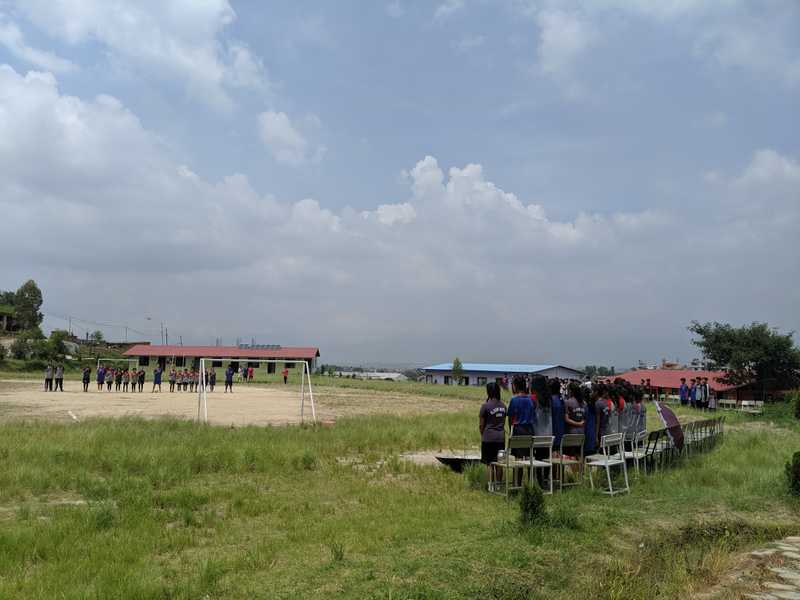 Students on ground, ready to play football