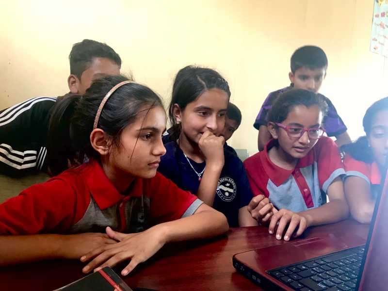 Students watching a video on a laptop